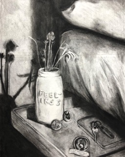 Black and white charcoal illustration of a bedside table. There is a jar with the text 'FEELINGS' that is holding dead flowers. There are also 3 pin-back buttons, a small journal, a key on a keyring with a keychain, and a fortune from a fortune cookie.